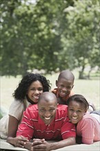 Family relaxing together in park