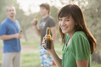 Woman drinking beer outdoors