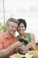Senior Caucasian couple toasting each other with wine