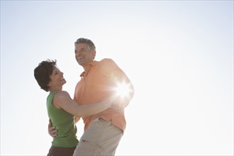 Caucasian couple dancing outdoors