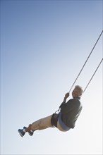 Senior African American woman on swing