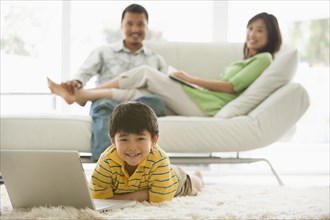 Boy using laptop in living room