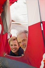 Senior Caucasian couple relaxing in tent