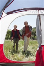 Senior Caucasian couple walking to campsite