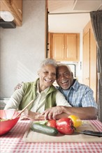 Mixed race Senior couple smiling in RV