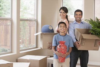 Hispanic family unpacking in new home