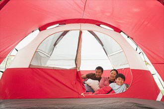 Asian family relaxing in tent