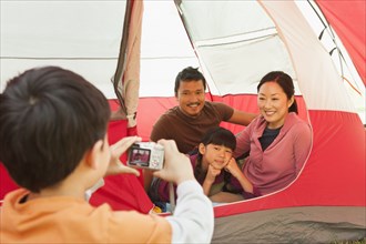 Family taking picture together in tent