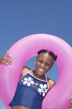 African American girl playing with inner tube