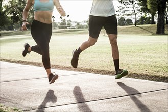 Couple running on path in park