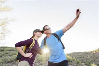 Hikers posing for cell phone selfie
