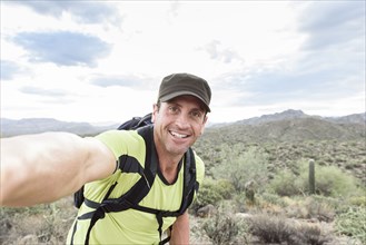 Hispanic man posing for selfie in desert