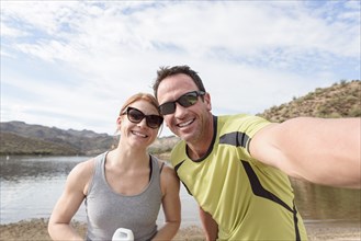 Couple posing for selfie at lake