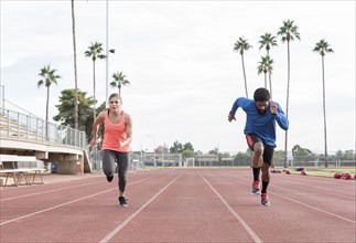 Man and woman running on track
