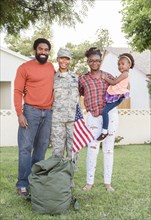 Portrait of black woman soldier with family