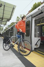 Man boarding subway with bike