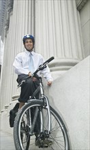 Portrait of businessman on bike