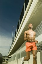 Male athlete running in urban surroundings
