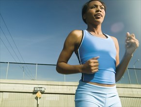 Female athlete running in urban surroundings