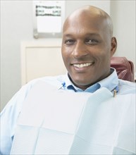 African man smiling in dentist's chair