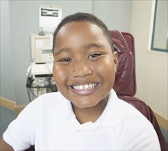 African boy smiling in dentist's chair
