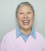 Close up of senior Asian woman laughing