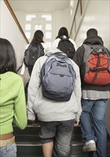 Group of students walking up stairs at school
