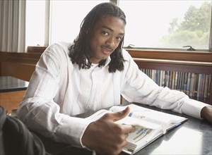 Young African man with text book