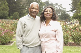 Senior African couple smiling outdoors