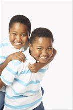 Young African twin brothers smiling