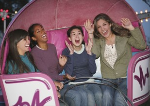 Multi-ethnic girls on amusement park ride