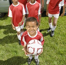 Mixed Race boy holding soccer ball