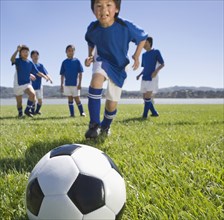 Multi-ethnic children playing soccer