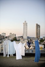 Laundry on clothes line on urban rooftop