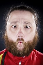 Bearded man puckering his mouth