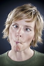 Caucasian woman puckering her mouth