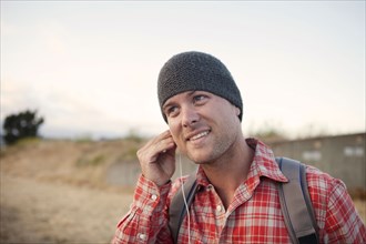 Man putting in earbuds in remote area