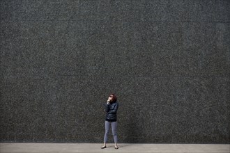 Korean woman standing in city sidewalk