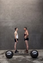 Caucasian weight lifters examining each other