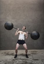 Skinny Caucasian weight lifter straining