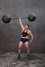 Caucasian weight lifter holding weights