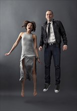 Couple jumping together in studio