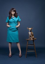 Mixed race businesswoman with dog on pedestal