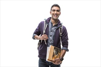 Indian student carrying books and backpack