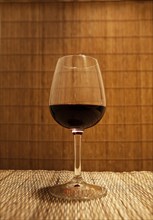 Close up of glass of red wine on table