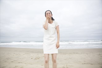 Woman laughing on beach