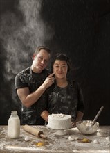 Messy couple baking cake