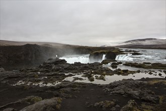 Rock formation cliffs near remote waterfall