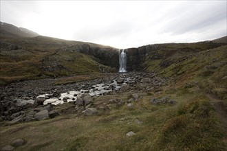 Waterfall and rocky stream in remote field