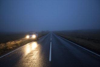 Car on remote road at night